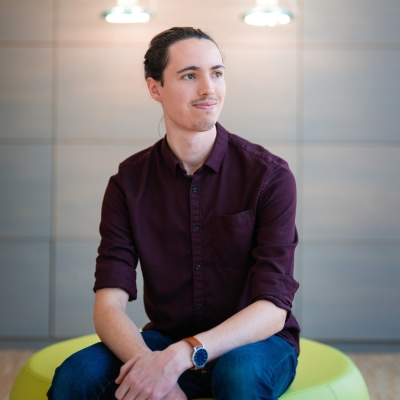 A portrait photograph of the author from the waist up